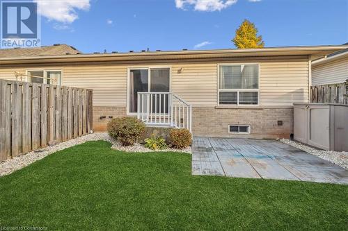 Rear view of house featuring a patio area and a lawn - 24 Kenyon Crescent Unit# 45, Grimsby, ON - Outdoor With Exterior