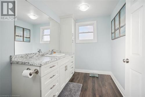 Bathroom featuring hardwood / wood-style floors, vanity, and a healthy amount of sunlight - 25 Rockwood Avenue, St. Catharines, ON - Indoor Photo Showing Bathroom