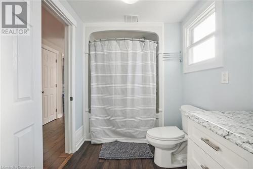 Bathroom with vanity, hardwood / wood-style floors, toilet, and a shower with curtain - 25 Rockwood Avenue, St. Catharines, ON - Indoor Photo Showing Bathroom