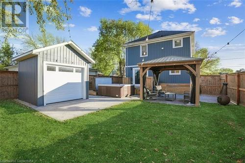 Rear view of house featuring a yard, an outdoor structure, central AC unit, a gazebo, and a patio - 25 Rockwood Avenue, St. Catharines, ON - Outdoor With Deck Patio Veranda