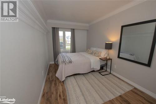 Bedroom with hardwood / wood-style floors and crown molding - 104 Kellies Way, The Blue Mountains, ON - Indoor Photo Showing Bedroom