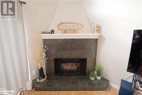 Details featuring a fireplace and hardwood / wood-style flooring - 104 Kellies Way, The Blue Mountains, ON - Indoor Photo Showing Living Room With Fireplace