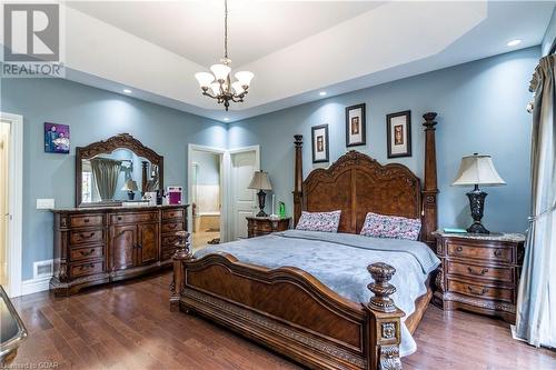 Bedroom featuring wood-type flooring and a chandelier - 59 Dominion Drive, Guelph, ON - Indoor Photo Showing Bedroom