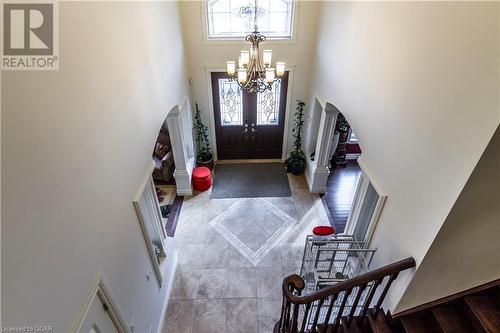 Foyer entrance with a high ceiling, an inviting chandelier, and a healthy amount of sunlight - 59 Dominion Drive, Guelph, ON - Indoor Photo Showing Other Room