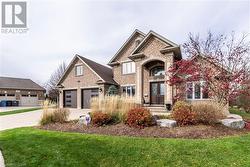 View of front of property with french doors and a front lawn - 