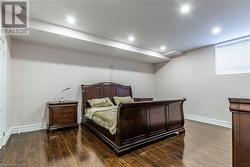 Bedroom with dark hardwood / wood-style floors - 