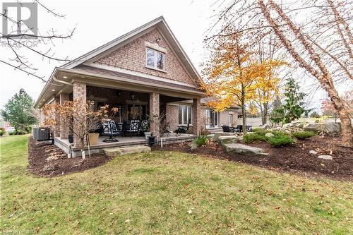 Back of house with covered porch, a yard, and central AC - 59 Dominion Drive, Guelph, ON - Outdoor