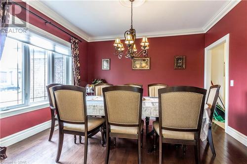 Dining room with hardwood / wood-style floors, crown molding, and a chandelier - 59 Dominion Drive, Guelph, ON - Indoor Photo Showing Dining Room