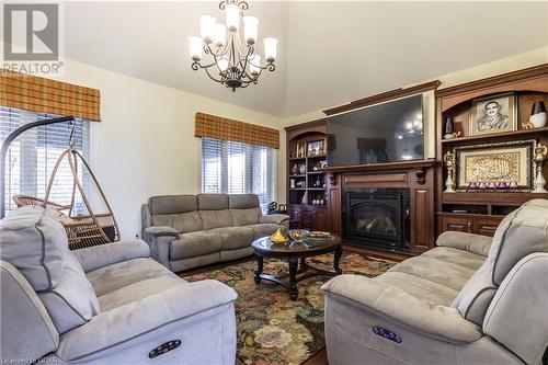 Living room featuring a notable chandelier - 59 Dominion Drive, Guelph, ON - Indoor Photo Showing Living Room With Fireplace