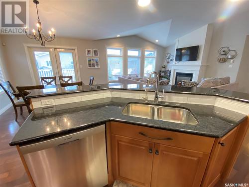 26 Aspen Place, Yorkton, SK - Indoor Photo Showing Kitchen With Fireplace With Double Sink