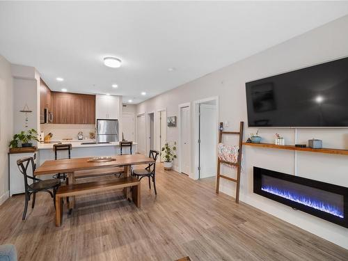 107-6540 Metral Dr, Nanaimo, BC - Indoor Photo Showing Living Room With Fireplace