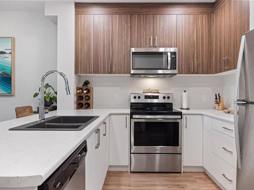 107-6540 Metral Dr, Nanaimo, BC - Indoor Photo Showing Kitchen With Stainless Steel Kitchen With Double Sink With Upgraded Kitchen