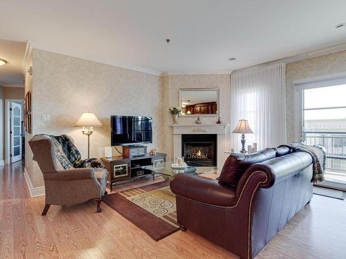 Living room - 25 Rue Des Manoirs, Charlemagne, QC - Indoor Photo Showing Living Room With Fireplace