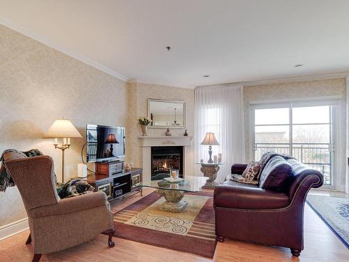 Living room - 25 Rue Des Manoirs, Charlemagne, QC - Indoor Photo Showing Living Room With Fireplace