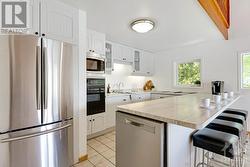 Contemporary white bright kitchen with large island-breakfast bar - 