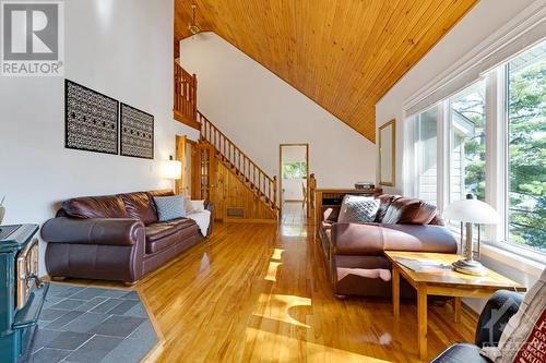 Off the family room is staircase to second floor - 4055 Hanley Lane, Perth, ON - Indoor Photo Showing Living Room