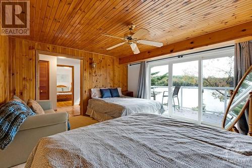 Lower level's other bedroom with patio doors to deck. - 4055 Hanley Lane, Perth, ON - Indoor Photo Showing Bedroom