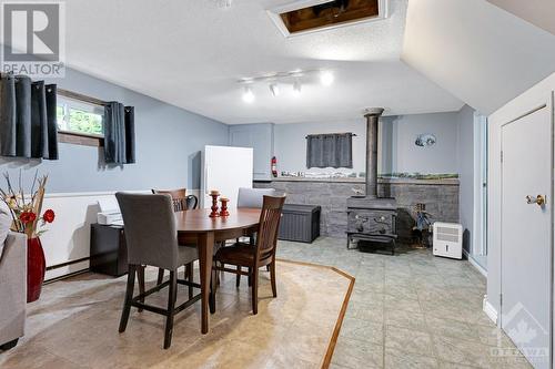 Efficient cast iron wood stove heats whole house (vent in ceiling has circulating fan) - 479 Drummond Concession 11 Road, Carleton Place, ON - Indoor Photo Showing Dining Room