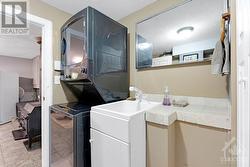 Lower level powder room with laundry station - 