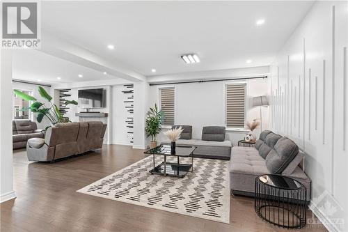 Main Level- Living room with design wall and pot lights above. - 272 Big Dipper Street, Ottawa, ON - Indoor Photo Showing Living Room