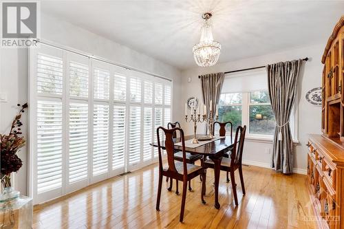 Formal dining room wall of patios doors with built-in California shutters - 28 Mountain View Lane, Westport, ON - Indoor Photo Showing Dining Room