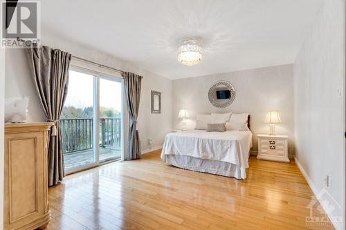 Primary retreat with patio doors to balcony - 28 Mountain View Lane, Westport, ON - Indoor Photo Showing Bedroom