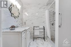 Luxury ensuite has marble vanity and ceramic shower - 