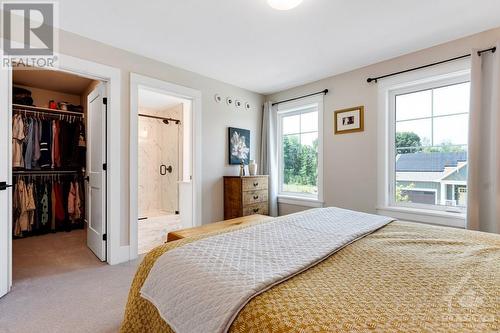 Primary bedroom walk-in closet - 27 Shelter Cove Drive, Westport, ON - Indoor Photo Showing Bedroom