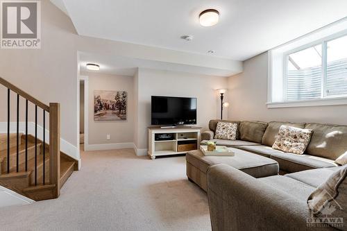 Lower level family room full of light from big windows - 27 Shelter Cove Drive, Westport, ON - Indoor Photo Showing Living Room