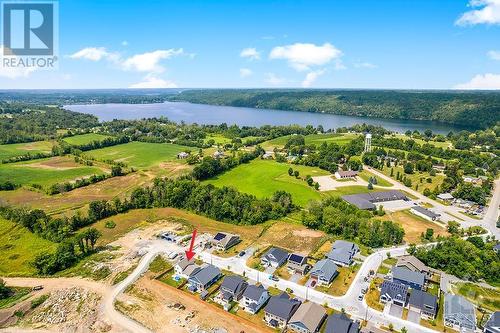 Located in Westport surrounded by sandy beach, walking & cycling trails plus boat launches at Upper Rideau Lake, Sand Lake & Wolfe Lake - 27 Shelter Cove Drive, Westport, ON - Outdoor With Body Of Water With View