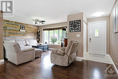 Living room grand bay window and lovely accent wall - 9334 Branch Road, North Augusta, ON - Indoor Photo Showing Living Room