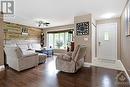 Living room grand bay window and lovely accent wall - 9334 Branch Road, North Augusta, ON  - Indoor Photo Showing Living Room 