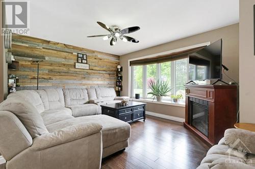 Bay window has built-in blinds - 9334 Branch Road, North Augusta, ON - Indoor Photo Showing Living Room With Fireplace