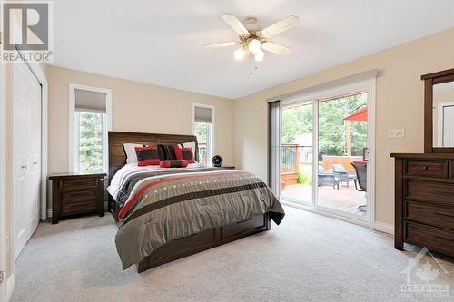 Primary suite has its own access to deck plus inspiring view of picturesque backyard - 9334 Branch Road, North Augusta, ON - Indoor Photo Showing Bedroom