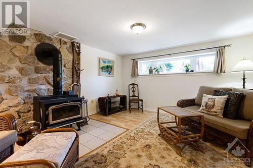 Lower level family room with cozy woodstove - 124 Second Avenue, Carleton Place, ON - Indoor Photo Showing Other Room With Fireplace