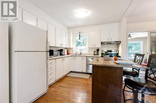 White bright kitchen with convenient island-breakfast bar - 124 Second Avenue, Carleton Place, ON - Indoor Photo Showing Kitchen