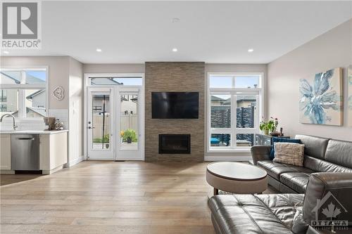 Walkout to back deck off kitchen & living room. - 68 Hubble Heights, Ottawa, ON - Indoor Photo Showing Living Room With Fireplace