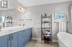 Primary en suite w/ dual sinks and private toilet space. - 