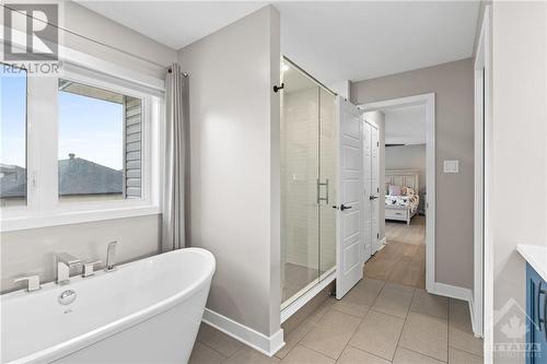 Deep soaker tub & glass enclosed rain shower! - 68 Hubble Heights, Ottawa, ON - Indoor Photo Showing Bathroom