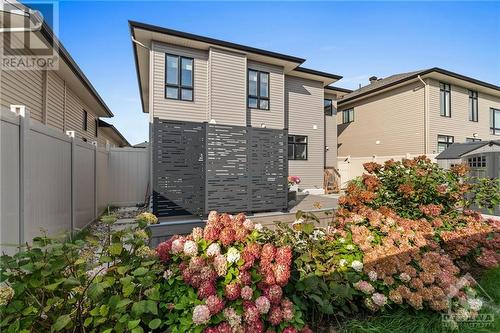 Fully landscaped garden, stepping stones and additional privacy wall along the deck edges. - 68 Hubble Heights, Ottawa, ON - Outdoor With Exterior