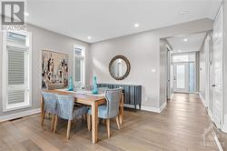 Dining room- Pot lights above and windows for natural light. Custom Blinds! - 