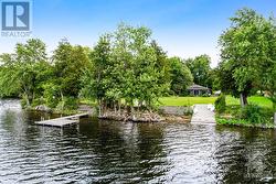 Easy access to 185' clear waterfront with dock and concrete boat launch - 