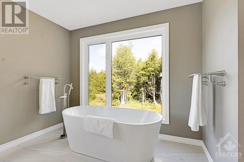 master ensuite soaker tub with a view over the forest - 1608 Nolans Road, Montague, ON - Indoor