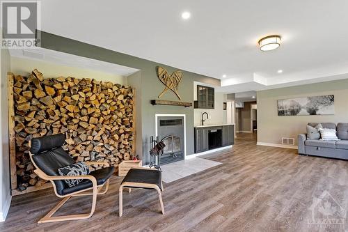 cozy fireplace in the lower level rec room - 1608 Nolans Road, Montague, ON - Indoor Photo Showing Other Room With Fireplace