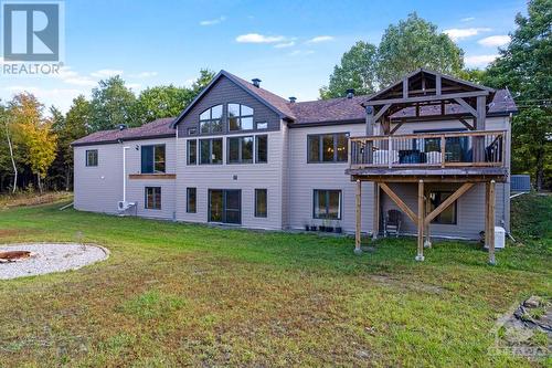 back of the house, with pea gravel firepit area in the bottom left - 1608 Nolans Road, Montague, ON - Outdoor With Deck Patio Veranda