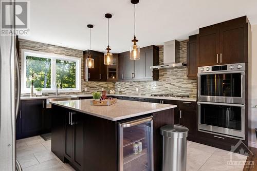 gas range, double electric built-in ovens, and a wine fridge built into the island - 1608 Nolans Road, Montague, ON - Indoor Photo Showing Kitchen With Upgraded Kitchen