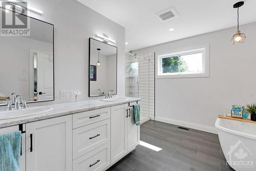 Luxurious ensuite ceramic floor, two-sink vanity, soaker tub and glass shower with rainhead - 1074 Barrett Chute Road, Calabogie, ON - Indoor Photo Showing Bathroom