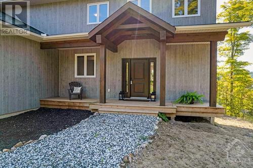 Attractive custom timber front entry - 1074 Barrett Chute Road, Calabogie, ON - Outdoor With Deck Patio Veranda With Exterior