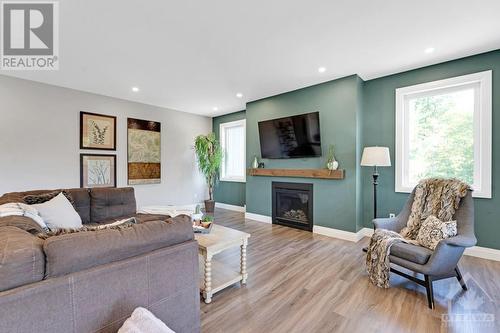 Propane gas fireplace with custom hardwood mantle - 1074 Barrett Chute Road, Calabogie, ON - Indoor Photo Showing Living Room With Fireplace