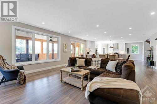 Living spaces wrapped in windows with forever views of the outdoors - 1074 Barrett Chute Road, Calabogie, ON - Indoor Photo Showing Living Room